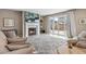 This cozy living room has a stone fireplace and sliding glass doors which allow for lots of natural light at 18036 E 99Th Ave, Commerce City, CO 80022