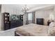Comfortable main bedroom featuring carpet, chandelier, large dresser with TV, and closet at 18036 E 99Th Ave, Commerce City, CO 80022