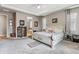 Inviting primary bedroom with sitting area, carpet, and tray ceiling at 18036 E 99Th Ave, Commerce City, CO 80022
