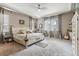 Spacious primary bedroom with tray ceilings, plush carpeting, and natural light at 18036 E 99Th Ave, Commerce City, CO 80022