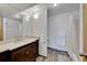 Bathroom featuring dark vanity with a large mirror and a shower tub combination at 31324 Kings Vly, Conifer, CO 80433
