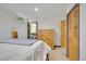 Bedroom with outside access to balcony, wood doors, a chest of drawers, and carpeted floors at 31324 Kings Vly, Conifer, CO 80433