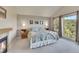 Bright bedroom with a fireplace, carpet, and large windows showing a beautiful tree view at 31324 Kings Vly, Conifer, CO 80433