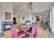 Bright dining area features a fireplace, wood floors, and an open floor plan to the kitchen at 31324 Kings Vly, Conifer, CO 80433