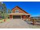 A charming mountain home with a well-kept gravel driveway and mountain views at 31324 Kings Vly, Conifer, CO 80433