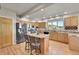 Updated kitchen with stainless steel appliances, granite countertops, and a functional center island at 31324 Kings Vly, Conifer, CO 80433