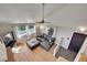 Cozy living room featuring hardwood floors, a comfortable sectional, and plenty of natural light at 31324 Kings Vly, Conifer, CO 80433