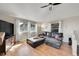 Comfortable living room with hardwood floors, windows, and a large leather sectional sofa and stylish furnishings at 31324 Kings Vly, Conifer, CO 80433
