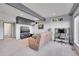 Spacious living room with a large TV, desk space, and access to a bathroom at 31324 Kings Vly, Conifer, CO 80433