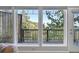 Up close window view from living room to the deck outside surrounded by beautiful green trees at 31324 Kings Vly, Conifer, CO 80433