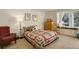 Cozy bedroom with an abundance of natural light from the window bench and patchwork quilt at 23634 Pondview Pl # B, Golden, CO 80401