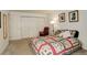 Comfortable bedroom with a decorative patchwork quilt, chair, and ample closet space at 23634 Pondview Pl # B, Golden, CO 80401