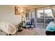 Bright bedroom area featuring a desk, a chair, and sliding glass doors to a balcony at 23634 Pondview Pl # B, Golden, CO 80401