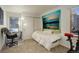 Well-lit bedroom with exercise bike, desk, chair, and decorative wall art at 23634 Pondview Pl # B, Golden, CO 80401