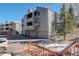 Three-story condo with multiple balconies, garage parking, and access stairs at 23634 Pondview Pl # B, Golden, CO 80401