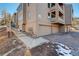 Three-story condo building featuring multiple balconies, garage parking, and well-maintained landscaping at 23634 Pondview Pl # B, Golden, CO 80401