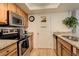 Bright kitchen with stainless steel appliances, granite countertops, and light wood cabinetry at 23634 Pondview Pl # B, Golden, CO 80401