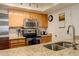 Well-lit kitchen features granite countertops, stainless steel appliances, and wooden cabinets at 23634 Pondview Pl # B, Golden, CO 80401