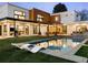 Stunning backyard oasis featuring a modern pool, lounge chairs, and expansive outdoor living spaces at 1 S Forest St, Denver, CO 80246