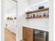 Stylish bar area featuring wood cabinets, stone countertops, and a wine refrigerator at 1 S Forest St, Denver, CO 80246