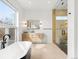 A luxurious bathroom features a soaking tub, modern vanity, and a glass-enclosed shower at 1 S Forest St, Denver, CO 80246