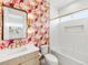 Chic bathroom showcasing patterned wallpaper, modern fixtures, and a soaking tub with a tile surround at 1 S Forest St, Denver, CO 80246