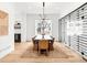 Elegant dining room with modern chandelier, large table, and adjacent wine storage at 1 S Forest St, Denver, CO 80246
