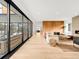 Open-concept living room with large windows, hardwood floors, and a modern fireplace at 1 S Forest St, Denver, CO 80246
