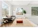 A bright living room with large windows, modern furniture, neutral rug, and a green houseplant at 1 S Forest St, Denver, CO 80246