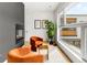 Bright living room features a modern fireplace, colorful chairs, neutral rug, and a large window at 1 S Forest St, Denver, CO 80246