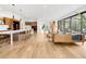 Open-concept living area with hardwood floors, a modern staircase, and abundant natural light at 1 S Forest St, Denver, CO 80246