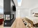 Modern bedroom with fireplace, TV, skylight, wood floors, and a stylish patterned rug at 1 S Forest St, Denver, CO 80246
