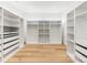 A large walk-in closet with a custom organizing system, white shelves and drawers at 1 S Forest St, Denver, CO 80246