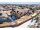 A high angle shot showcases a home with its fenced in yard within a community of homes at 9335 Dunraven Loop, Arvada, CO 80007