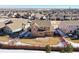 A high angle shot showcases a home with its fenced in yard within a community of homes at 9335 Dunraven Loop, Arvada, CO 80007
