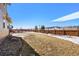 Large backyard with grass lawn, wooden fence, and partial mountain views at 9335 Dunraven Loop, Arvada, CO 80007