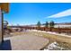 Well-maintained backyard featuring a stone patio and partial fencing at 9335 Dunraven Loop, Arvada, CO 80007