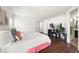 Bright bedroom featuring hardwood floors, ample natural light, closet and bathroom access at 9335 Dunraven Loop, Arvada, CO 80007