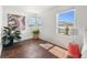 Sunlit bedroom with hardwood floors and scenic views from the windows at 9335 Dunraven Loop, Arvada, CO 80007