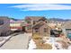A beautiful two-story home with mountain views, a two-car garage, and well-maintained lawn at 9335 Dunraven Loop, Arvada, CO 80007