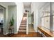 Bright foyer with hardwood floors, staircase, and natural light from a large window at 9335 Dunraven Loop, Arvada, CO 80007