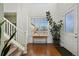 Bright foyer with a table, plant, staircase, and lots of natural light from the window at 9335 Dunraven Loop, Arvada, CO 80007