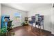 Spacious game room with pinball machines, hardwood floors and a bright window at 9335 Dunraven Loop, Arvada, CO 80007