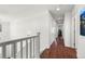 Bright hallway with hardwood floors, white walls, and multiple doors at 9335 Dunraven Loop, Arvada, CO 80007