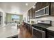 Bright kitchen area with stainless steel appliances and adjacent dining space with scenic views at 9335 Dunraven Loop, Arvada, CO 80007