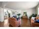 Open-concept living room with hardwood floors, neutral paint, and plenty of space for entertaining guests at 9335 Dunraven Loop, Arvada, CO 80007