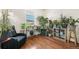 Living room with dark wood floors, chair, and well-lit window with mountain views at 9335 Dunraven Loop, Arvada, CO 80007