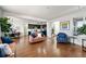 Cozy living area seamlessly connects to the kitchen, featuring hardwood floors and stylish modern furniture at 9335 Dunraven Loop, Arvada, CO 80007