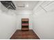 Spacious walk-in closet with shelving, hardwood floors, and a central dresser at 9335 Dunraven Loop, Arvada, CO 80007