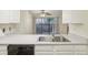 Kitchen features a double sink and dishwasher at 14190 E Temple Dr # O-04, Aurora, CO 80015